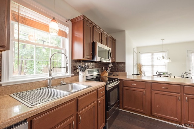 7418 Whirlaway Dr, Midlothian, VA 23112 - kitchen with appliances with stainless steel finishes, a sink, light countertops, hanging light fixtures, and backsplash
