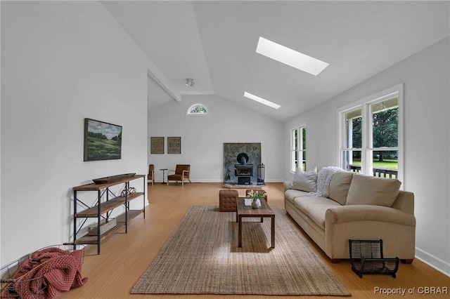 2480 Lees Neck Farm Rd, Saluda, VA 23149 - living area with a skylight, healthy amount of natural light, light wood finished floors, lofted ceiling, and baseboards