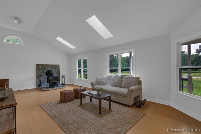 2480 Lees Neck Farm Rd, Saluda, VA 23149 - living room with a skylight, healthy amount of natural light, lofted ceiling, a wood stove, and wood finished floors