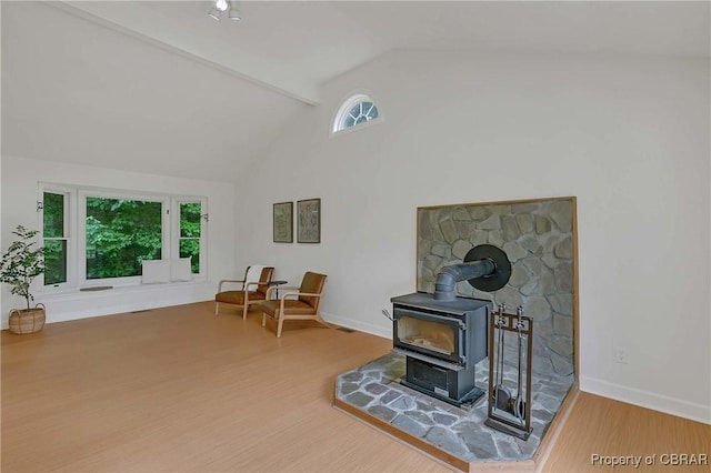 2480 Lees Neck Farm Rd, Saluda, VA 23149 - living area with wood finished floors, a wood stove, baseboards, beam ceiling, and high vaulted ceiling