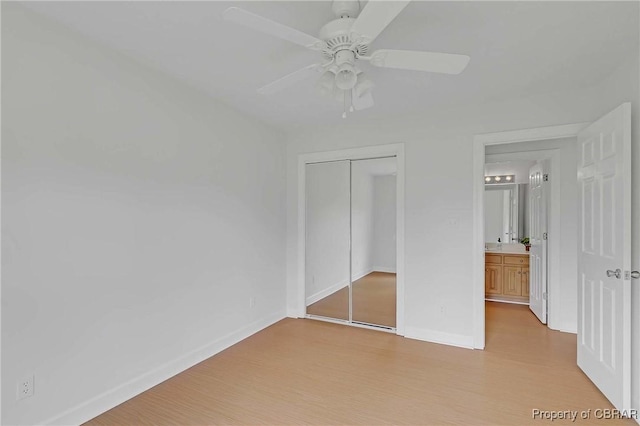 2480 Lees Neck Farm Rd, Saluda, VA 23149 - unfurnished bedroom with light wood-style floors, a closet, baseboards, and ceiling fan