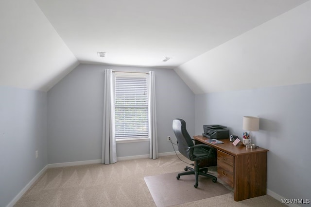 office featuring vaulted ceiling, light carpet, and baseboards