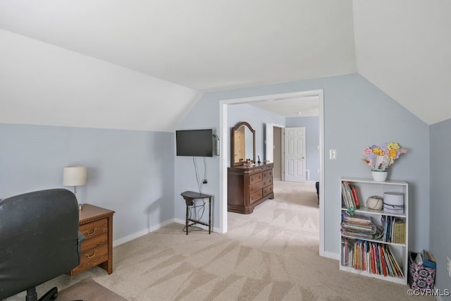carpeted office space with vaulted ceiling and baseboards