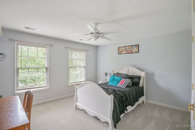 bedroom with light carpet, baseboards, and ceiling fan