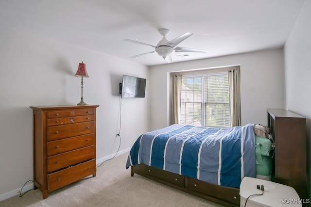 bedroom with light colored carpet, baseboards, and ceiling fan