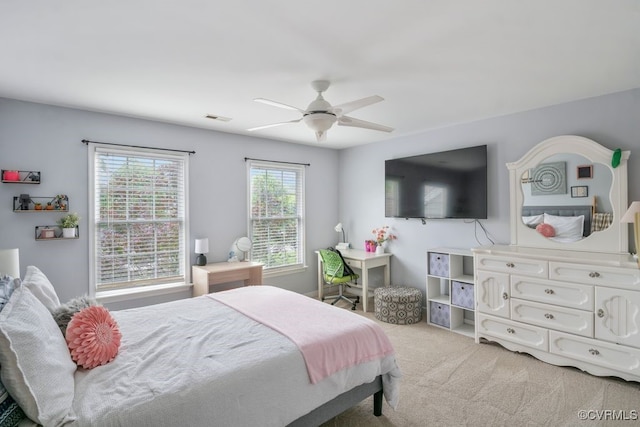 bedroom featuring light colored carpet and a ceiling fan