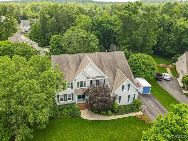 view of subject property with a heavily wooded area