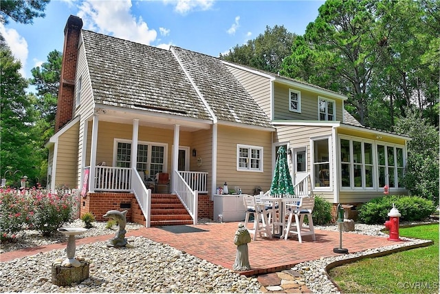29507 Monroe Rd Unit 1, Franklin, VA 23851 - back of property featuring a chimney, a sunroom, and a patio area