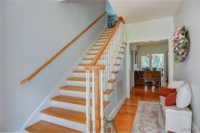 29507 Monroe Rd Unit 1, Franklin, VA 23851 - stairway featuring wood finished floors and a chandelier