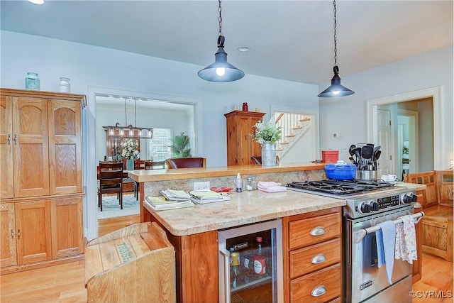 29507 Monroe Rd Unit 1, Franklin, VA 23851 - kitchen featuring wine cooler, high end stove, light wood-style floors, pendant lighting, and a center island