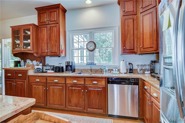 29507 Monroe Rd Unit 1, Franklin, VA 23851 - kitchen featuring appliances with stainless steel finishes, a sink, brown cabinetry, and glass insert cabinets