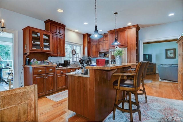 29507 Monroe Rd Unit 1, Franklin, VA 23851 - kitchen with stainless steel fridge with ice dispenser, light wood finished floors, a breakfast bar, a kitchen island, and recessed lighting