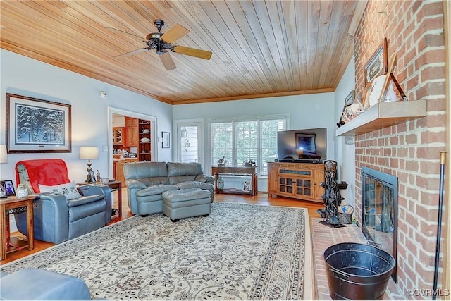 29507 Monroe Rd Unit 1, Franklin, VA 23851 - living room with ornamental molding, wooden ceiling, a ceiling fan, a brick fireplace, and wood finished floors