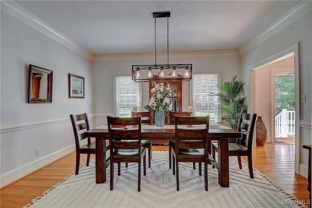 29507 Monroe Rd Unit 1, Franklin, VA 23851 - dining area featuring light wood-style floors, healthy amount of natural light, ornamental molding, and a chandelier