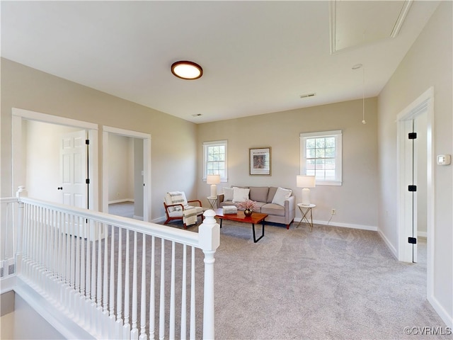 56 Mancha Ave, Claremont, VA 23899 - living room with attic access, healthy amount of natural light, carpet floors, and baseboards