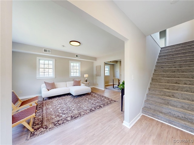56 Mancha Ave, Claremont, VA 23899 - living room featuring stairway and wood finished floors