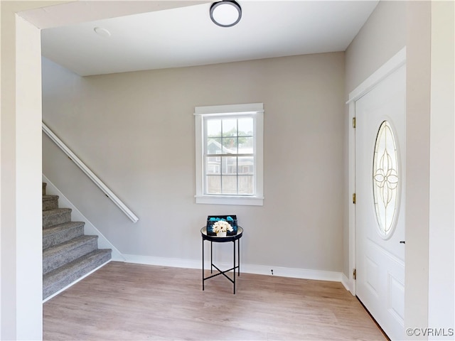 56 Mancha Ave, Claremont, VA 23899 - foyer with wood finished floors, baseboards, and stairs