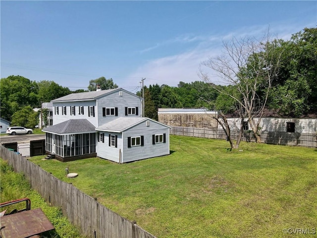 56 Mancha Ave, Claremont, VA 23899 - back of house featuring a sunroom, a shingled roof, and a fenced backyard