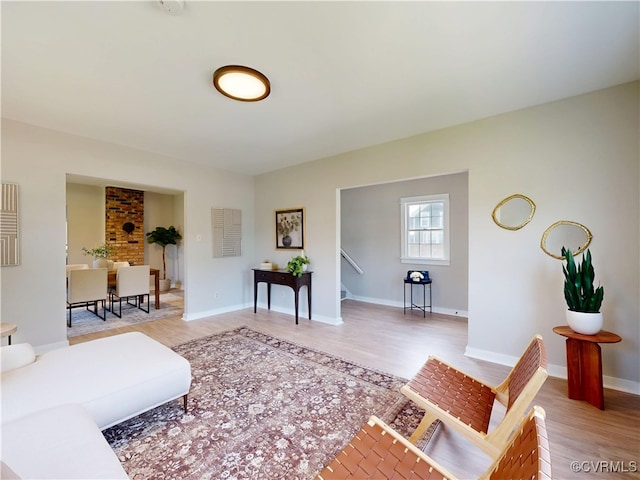 56 Mancha Ave, Claremont, VA 23899 - living room featuring light wood finished floors, stairway, and baseboards