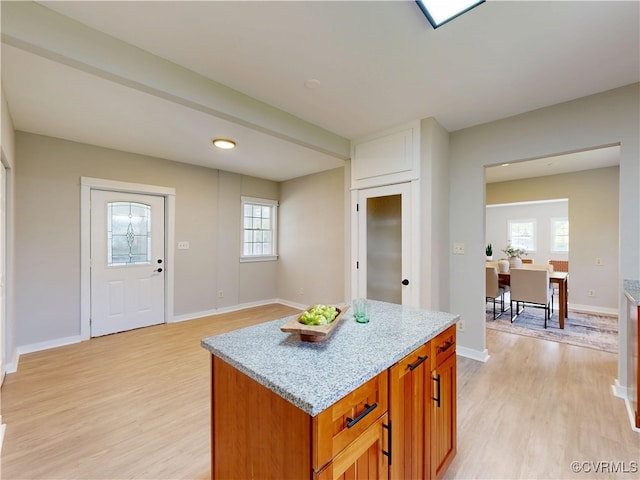 56 Mancha Ave, Claremont, VA 23899 - kitchen featuring light wood-style flooring, a kitchen island, and baseboards