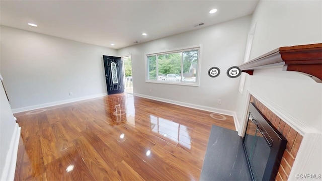 8803 Dena Dr, Henrico, VA 23229 - unfurnished living room featuring a fireplace with flush hearth, wood finished floors, baseboards, and recessed lighting