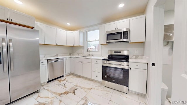 8803 Dena Dr, Henrico, VA 23229 - kitchen with appliances with stainless steel finishes, a sink, light marble finish floors, light countertops, and recessed lighting