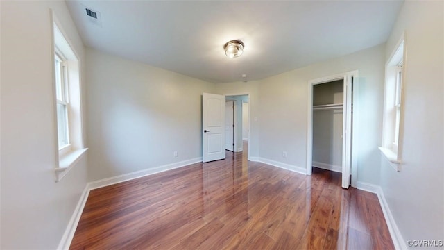 8803 Dena Dr, Henrico, VA 23229 - unfurnished bedroom with wood finished floors, a closet, and baseboards