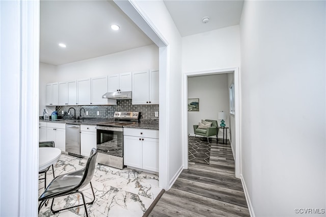 208 E 18th St, Richmond, VA 23224 - kitchen with stainless steel appliances, under cabinet range hood, white cabinets, backsplash, and recessed lighting