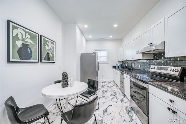 208 E 18th St, Richmond, VA 23224 - kitchen with under cabinet range hood, stainless steel appliances, a sink, light marble finish floors, and white cabinets
