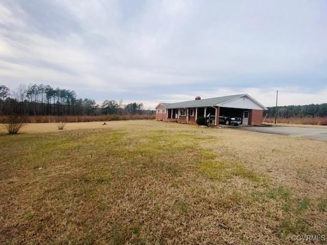 5939 Dry Bread Rd, Emporia, VA 23847 - view of grassy yard featuring a carport and driveway