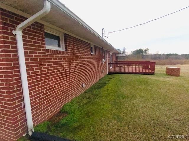 5939 Dry Bread Rd, Emporia, VA 23847 - view of side of property with a yard, brick siding, and a wooden deck