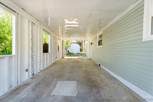 2519 Deerfield Dr, Petersburg, VA 23805 - view of patio featuring a storage unit, an outbuilding, and a carport