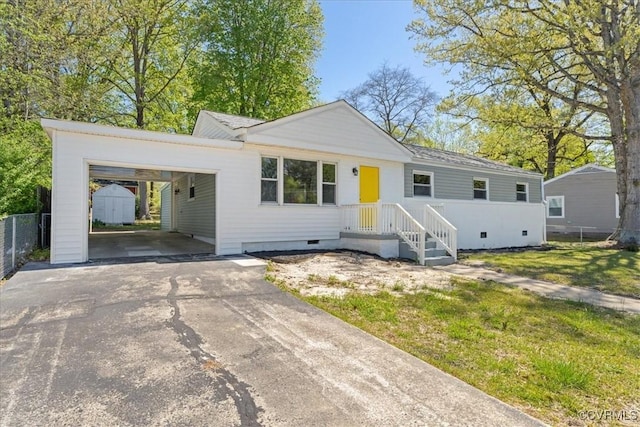 2519 Deerfield Dr, Petersburg, VA 23805 - ranch-style house featuring driveway, a storage unit, crawl space, an outbuilding, and an attached carport