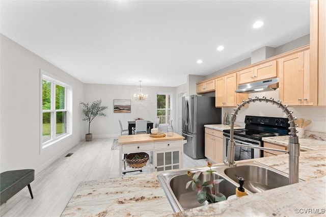 5239 Old Buckingham Rd, Powhatan, VA 23139 - kitchen featuring stainless steel appliances, light brown cabinetry, a chandelier, under cabinet range hood, and light wood-type flooring