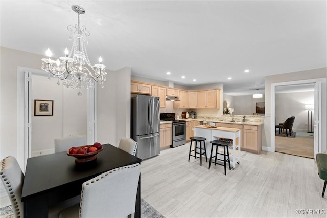 5239 Old Buckingham Rd, Powhatan, VA 23139 - kitchen featuring stainless steel appliances, light brown cabinetry, light countertops, a chandelier, and a breakfast bar