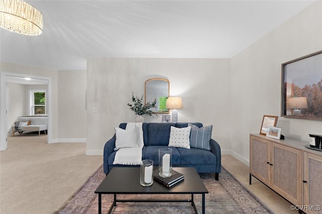 5239 Old Buckingham Rd, Powhatan, VA 23139 - living room featuring light colored carpet, baseboards, and a chandelier