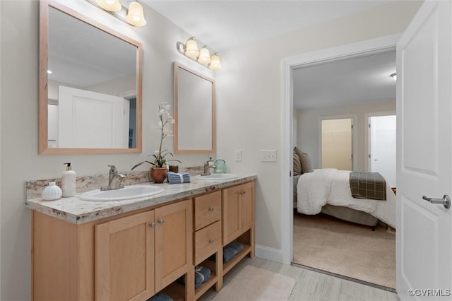 5239 Old Buckingham Rd, Powhatan, VA 23139 - ensuite bathroom featuring double vanity, wood finished floors, and baseboards