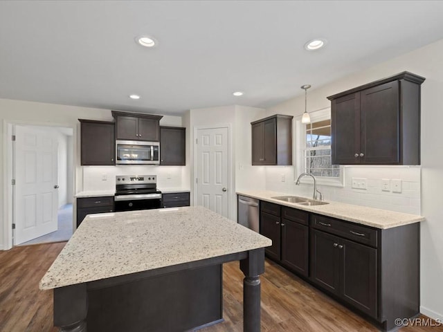 1146 Clayton Rd, Powhatan, VA 23139 - kitchen with appliances with stainless steel finishes, a sink, dark wood-style floors, tasteful backsplash, and pendant lighting