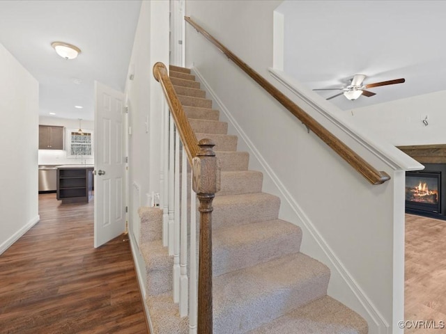 1146 Clayton Rd, Powhatan, VA 23139 - stairway featuring wood finished floors, a glass covered fireplace, ceiling fan, baseboards, and recessed lighting