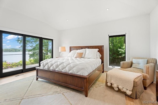 1665 Wilton Creek Rd, Hartfield, VA 23071 - bedroom featuring access to outside, multiple windows, vaulted ceiling, and light wood-type flooring