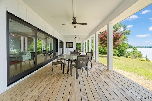 1665 Wilton Creek Rd, Hartfield, VA 23071 - wooden deck with outdoor dining area, a water view, a yard, and a ceiling fan