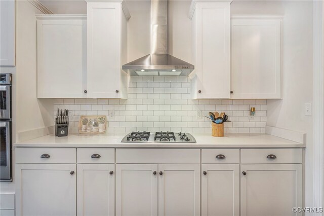 41 Pine Shadow Ct, Troy, VA 22974 - kitchen with wall chimney exhaust hood, stainless steel appliances, white cabinetry, and backsplash