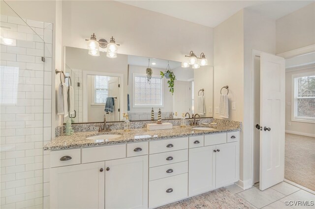 41 Pine Shadow Ct, Troy, VA 22974 - bathroom featuring tile patterned flooring, a tile shower, double vanity, and baseboards