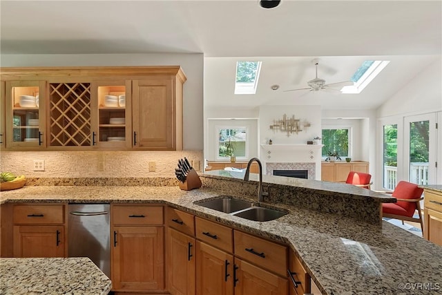 13700 Harbourwood Rd, Midlothian, VA 23112 - kitchen with a sink, a skylight, a fireplace, light stone counters, and lofted ceiling