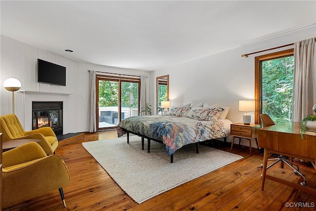 13700 Harbourwood Rd, Midlothian, VA 23112 - bedroom with access to exterior, a glass covered fireplace, and hardwood / wood-style floors
