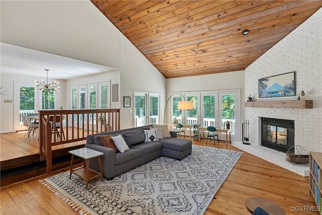 13700 Harbourwood Rd, Midlothian, VA 23112 - living room with a chandelier, high vaulted ceiling, hardwood / wood-style floors, and a brick fireplace