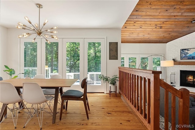 13700 Harbourwood Rd, Midlothian, VA 23112 - dining space featuring a chandelier, light wood-type flooring, a brick fireplace, and lofted ceiling