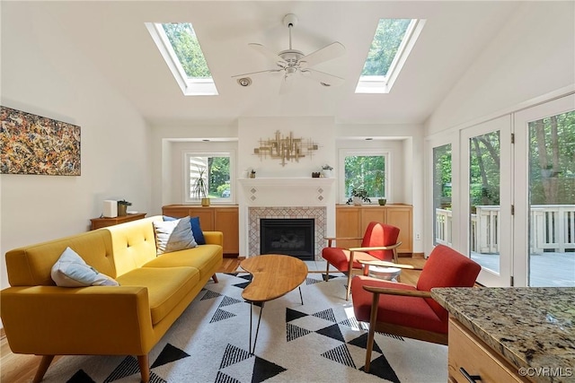 13700 Harbourwood Rd, Midlothian, VA 23112 - living area with a skylight, high vaulted ceiling, a fireplace, a ceiling fan, and light wood finished floors