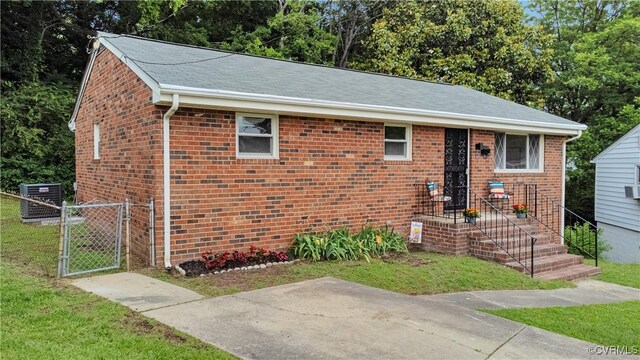 14 Gloucester Cir, Petersburg, VA 23803 - view of front of house featuring cooling unit, brick siding, and a gate