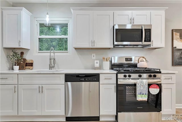 14 Gloucester Cir, Petersburg, VA 23803 - kitchen featuring stainless steel appliances, a sink, light countertops, white cabinets, and pendant lighting